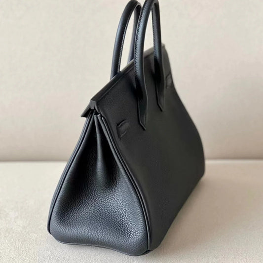 Sac à main en cuir noir avec cadenas doré – Maison Mathurine